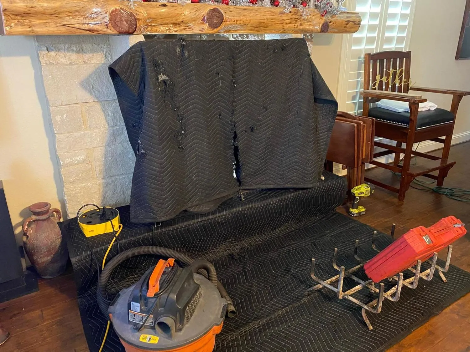 Fireplace sealed with protective blanket and vacuum during sweep setup