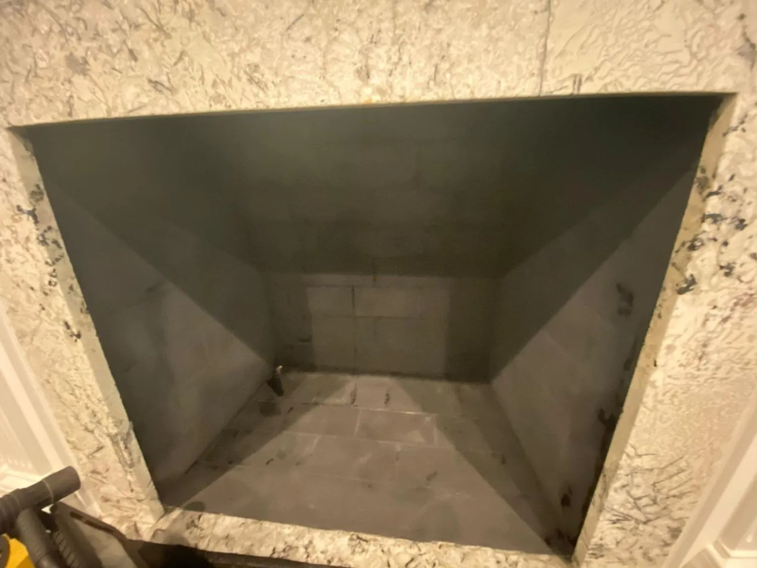 Empty clean tan brick firebox after sweeping service