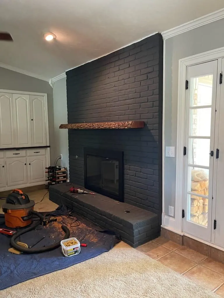 Living room fireplace remodel in progress with tools