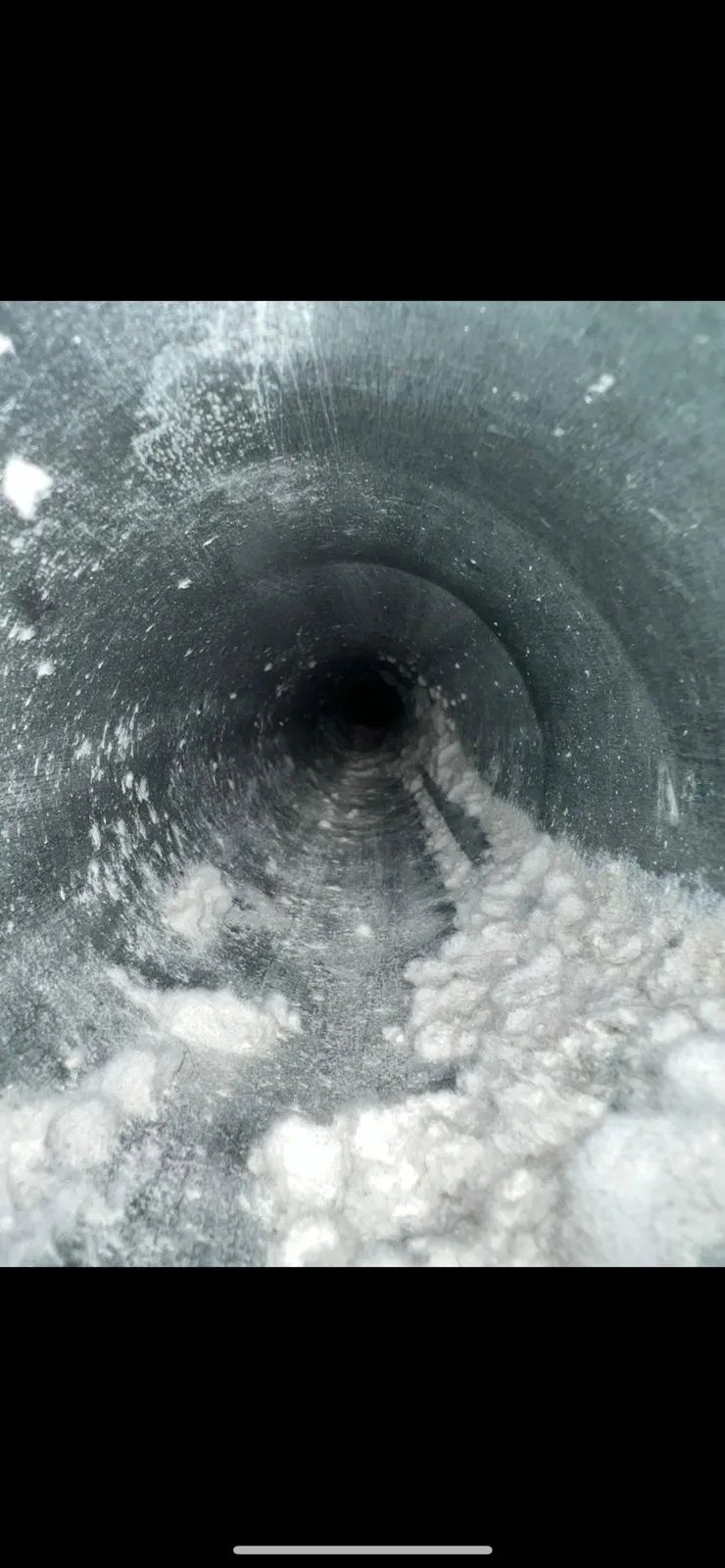 Inside of dryer vent clogged with lint before cleaning