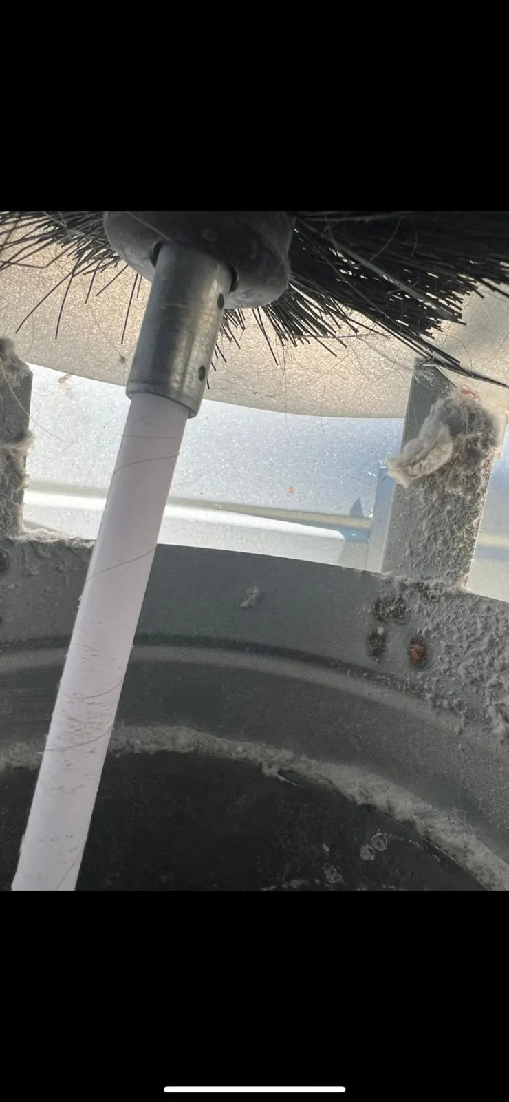 Rotary brush cleaning inside a dryer vent line
